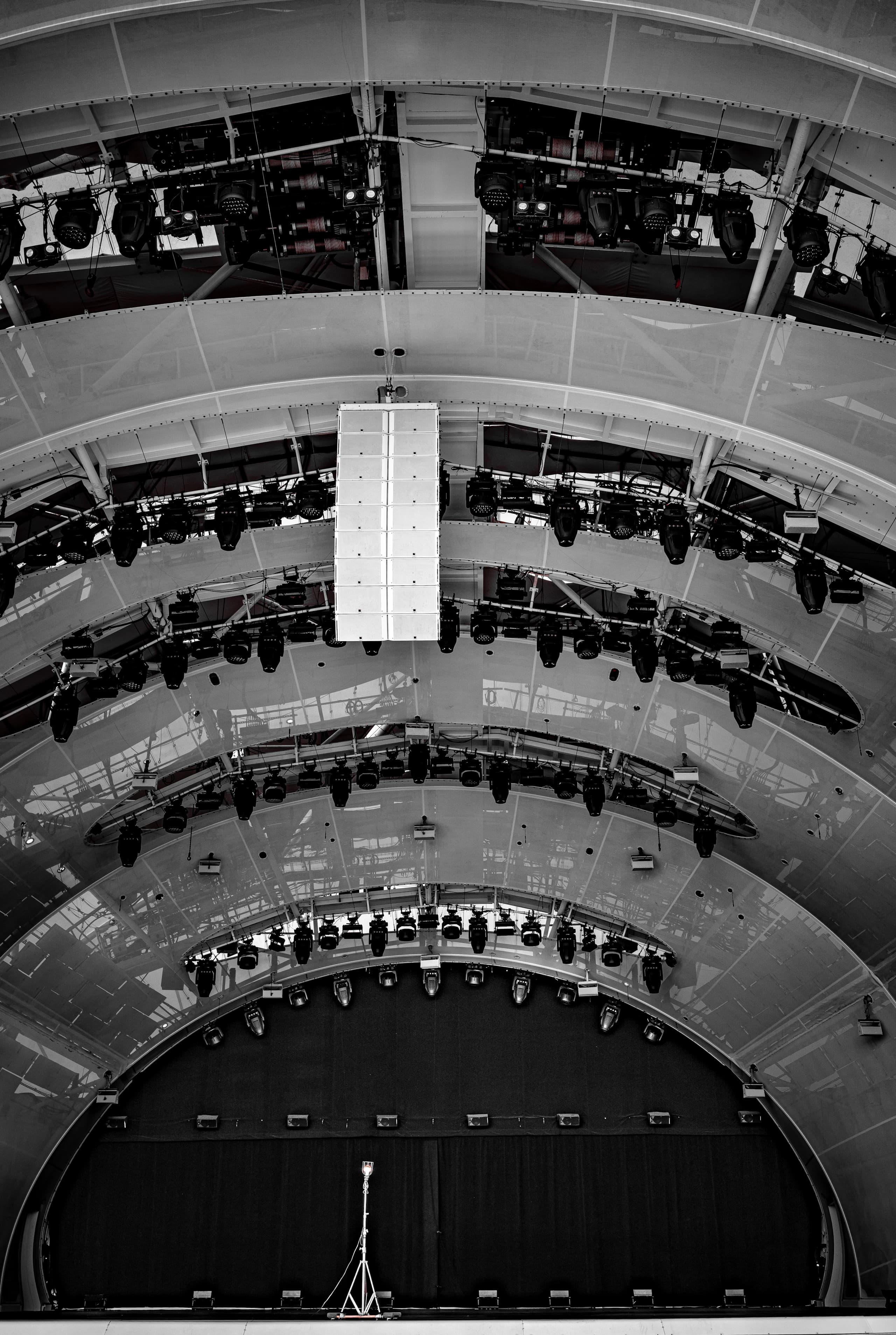 Dark exhibition setup with rigging and overhead technical structure